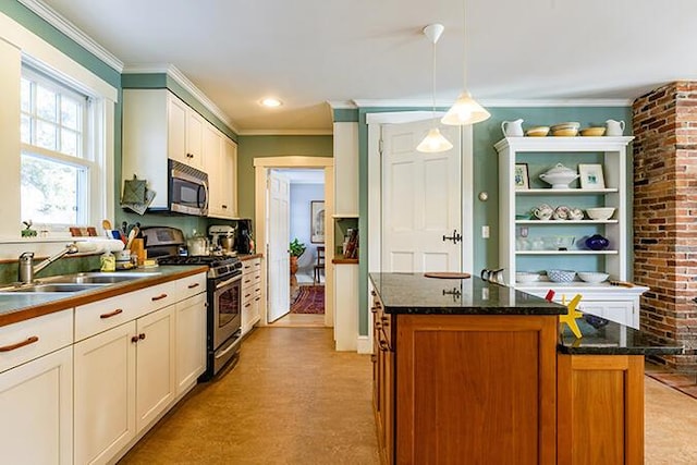 50 Peters Rd, Searsmont, ME 04973 - kitchen with a center island, white cabinets, decorative light fixtures, appliances with stainless steel finishes, and crown molding