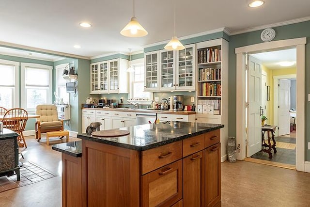 50 Peters Rd, Searsmont, ME 04973 - kitchen featuring brown cabinetry, glass insert cabinets, ornamental molding, and a healthy amount of sunlight