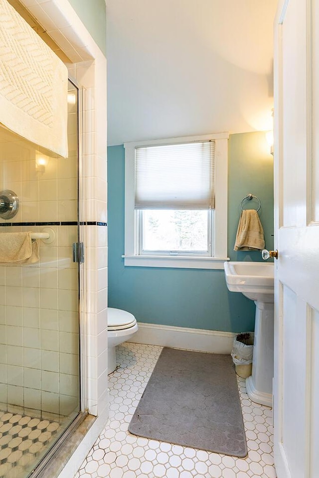 50 Peters Rd, Searsmont, ME 04973 - full bathroom featuring toilet, baseboards, and a stall shower