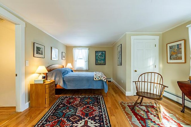 50 Peters Rd, Searsmont, ME 04973 - bedroom with light wood-style floors, crown molding, baseboard heating, a baseboard heating unit, and baseboards
