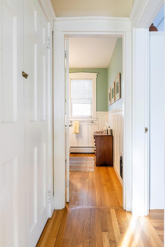 50 Peters Rd, Searsmont, ME 04973 - corridor featuring wood-type flooring, baseboard heating, and a wainscoted wall