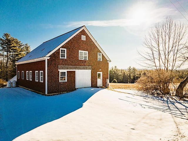 50 Peters Rd, Searsmont, ME 04973 - view of home's exterior featuring a garage, metal roof, and brick siding