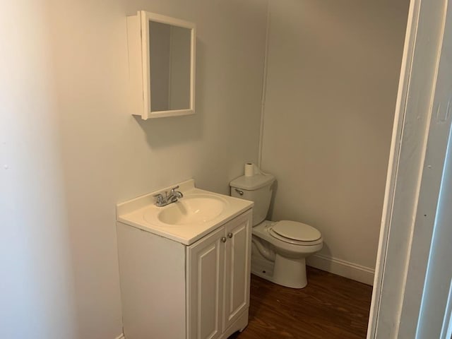 bathroom featuring hardwood / wood-style floors, vanity, and toilet