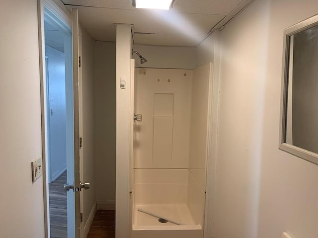 bathroom with wood-type flooring and walk in shower