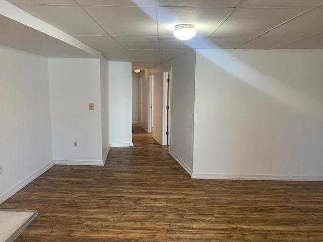 interior space with a paneled ceiling and dark wood-type flooring