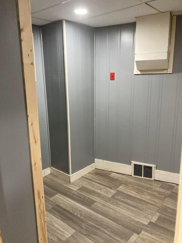 details with hardwood / wood-style flooring and a paneled ceiling