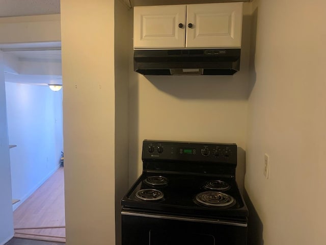 kitchen with white cabinetry and black electric range