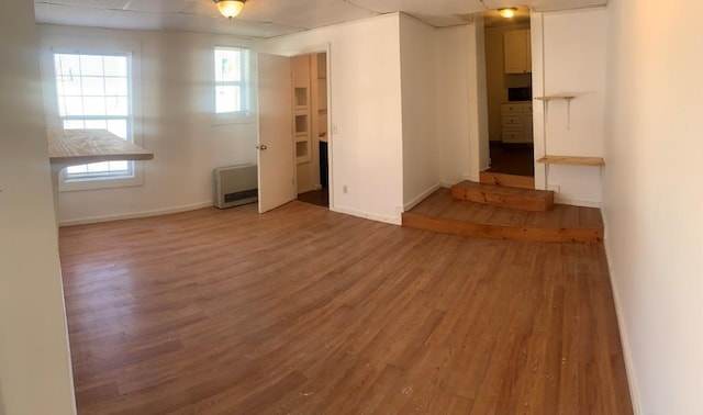 spare room with hardwood / wood-style flooring and heating unit