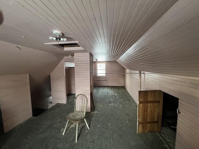 additional living space with lofted ceiling and wooden walls