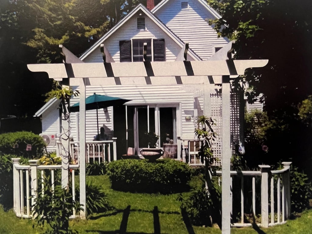 back of house featuring a pergola