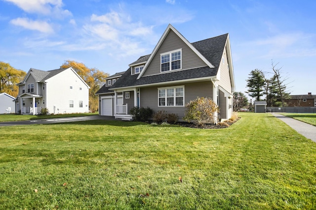 view of front of house featuring a front lawn and a garage