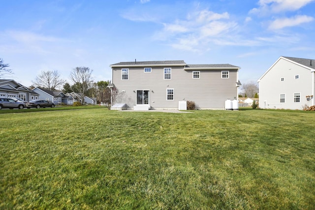 back of house with a lawn