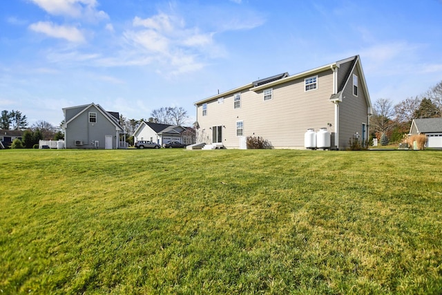 back of property featuring a yard