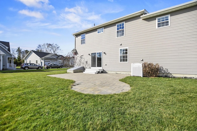 rear view of property featuring a yard and a patio