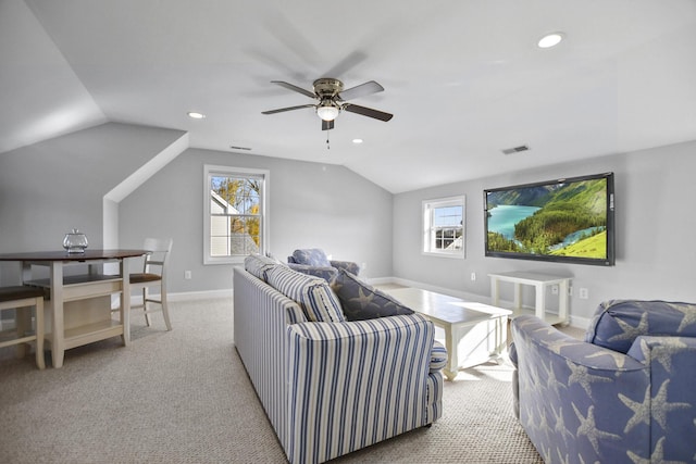 living room with ceiling fan, light colored carpet, vaulted ceiling, and a wealth of natural light