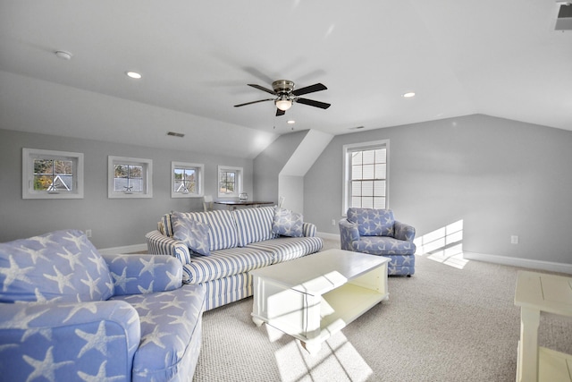 living room with ceiling fan, vaulted ceiling, and a healthy amount of sunlight