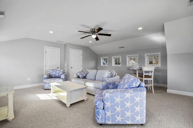 carpeted living room with ceiling fan and vaulted ceiling