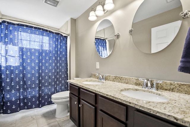 bathroom with toilet, vanity, tile patterned floors, and walk in shower