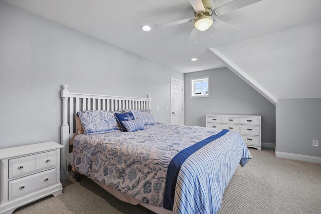 carpeted bedroom featuring ceiling fan and vaulted ceiling