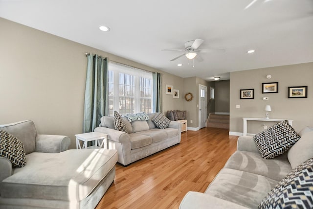 living room with ceiling fan and light wood-type flooring