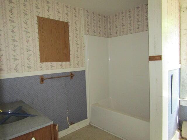 bathroom featuring vanity and a washtub