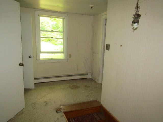 unfurnished room with a baseboard radiator