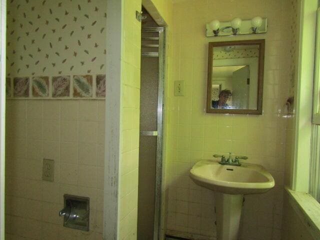 bathroom with tile walls