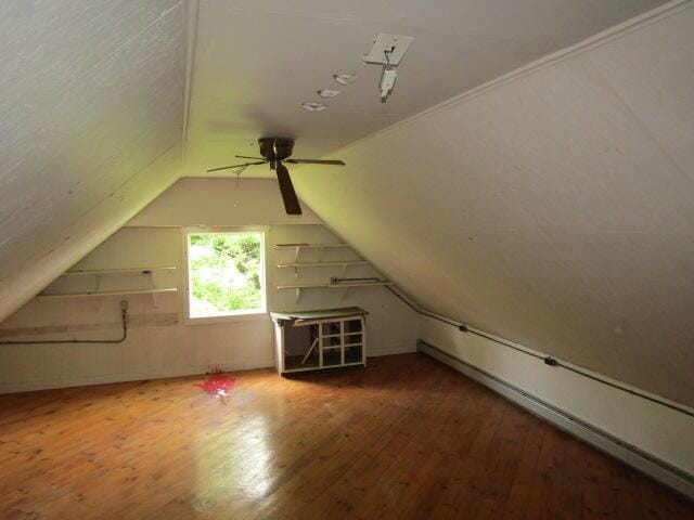 bonus room featuring a baseboard radiator, ceiling fan, lofted ceiling, and hardwood / wood-style flooring