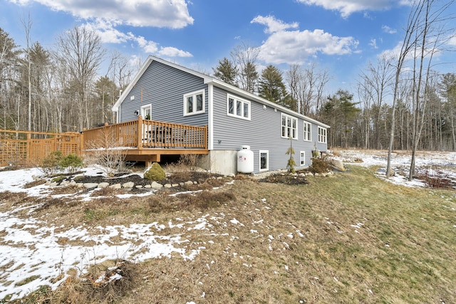 view of snowy exterior featuring a deck