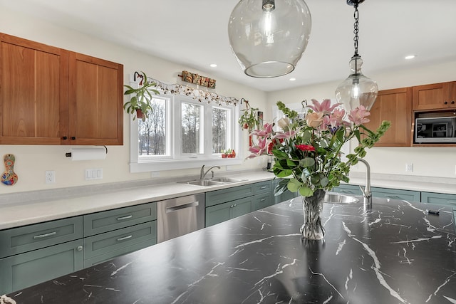 kitchen featuring stainless steel dishwasher, built in microwave, hanging light fixtures, and sink