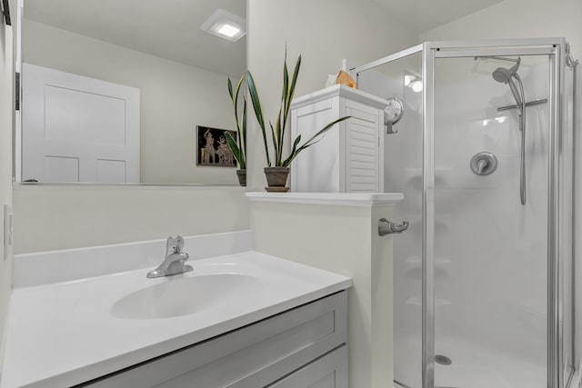 bathroom featuring an enclosed shower and vanity