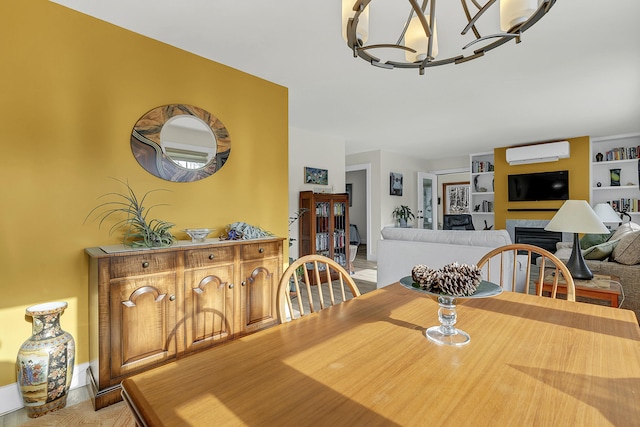 dining area featuring a notable chandelier, a wall mounted AC, and built in features