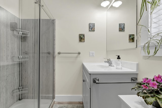 bathroom featuring walk in shower and vanity