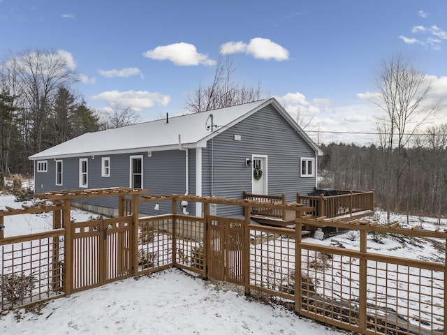 snow covered house with a deck