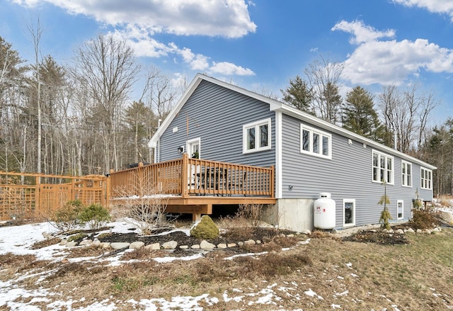 snow covered property featuring a wooden deck