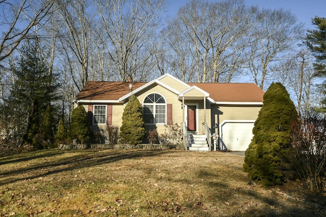 view of front of home with a garage and a front lawn