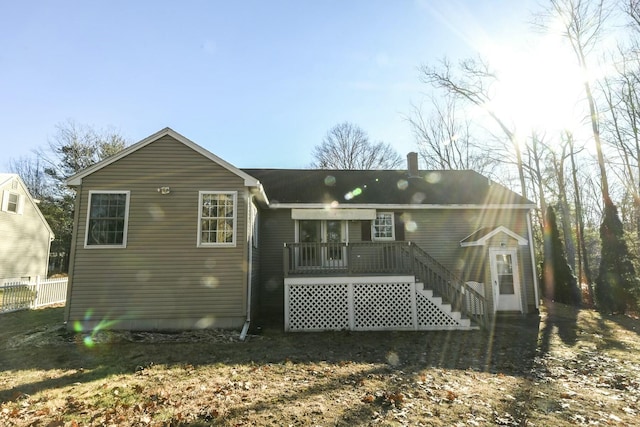 rear view of property featuring a wooden deck