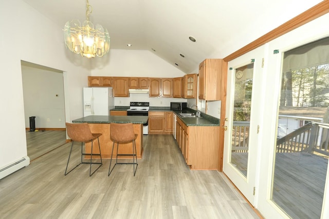 kitchen featuring white appliances, hanging light fixtures, a baseboard radiator, a kitchen island, and a chandelier