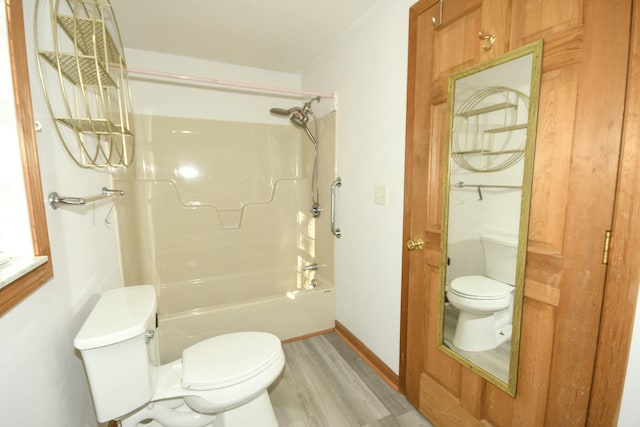 bathroom with hardwood / wood-style floors, toilet, and shower / bath combination