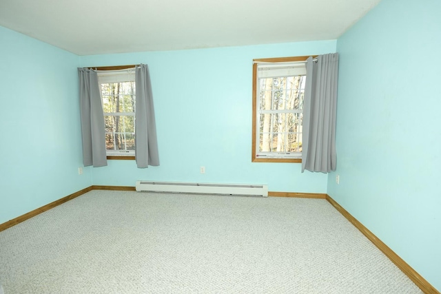 carpeted spare room with baseboard heating