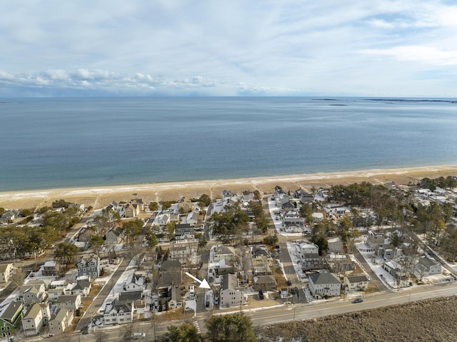 birds eye view of property with a view of the beach and a water view