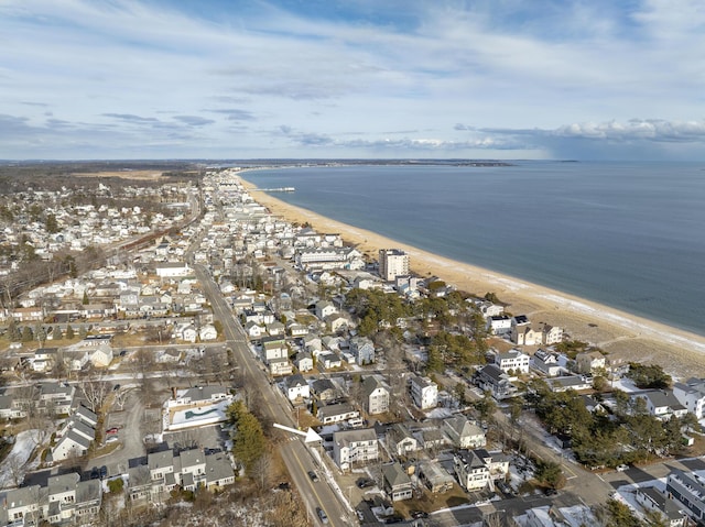 birds eye view of property featuring a water view and a beach view