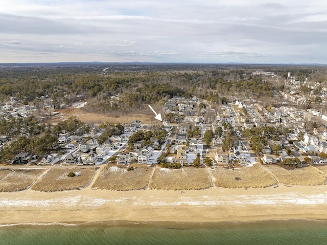 birds eye view of property featuring a water view and a beach view