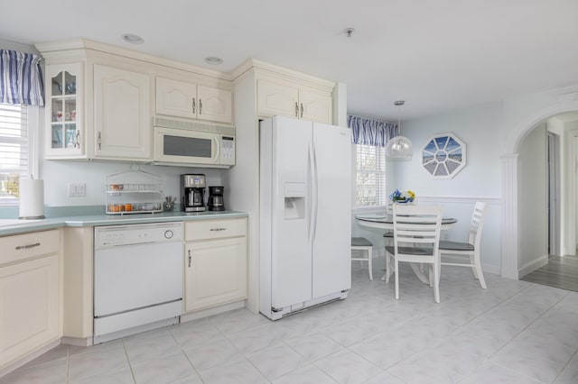 kitchen featuring white appliances and hanging light fixtures