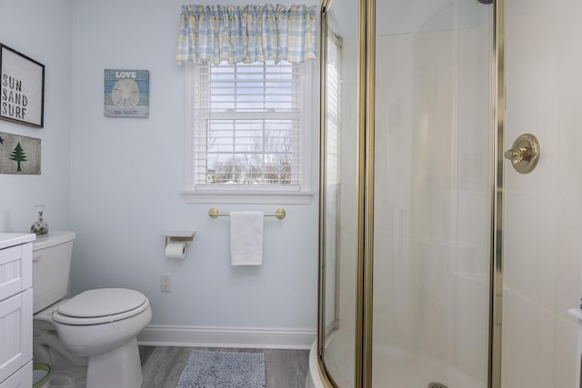 bathroom featuring walk in shower, vanity, toilet, and hardwood / wood-style flooring