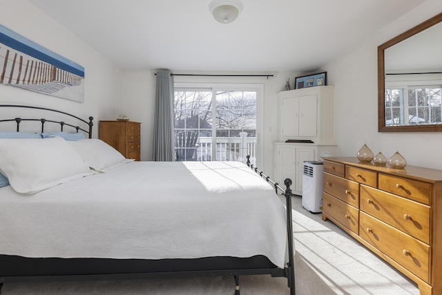 bedroom featuring light colored carpet and access to outside