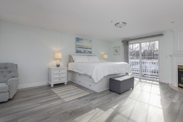 bedroom featuring access to outside and light wood-type flooring