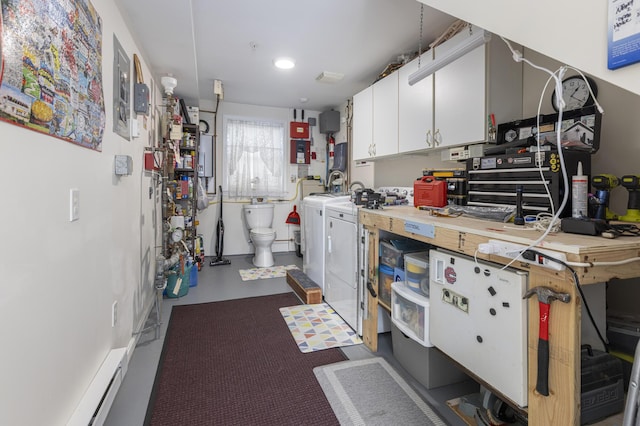 kitchen with white cabinets and washing machine and clothes dryer