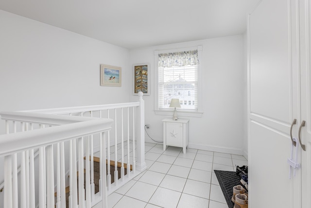 bedroom with light tile patterned floors and a crib