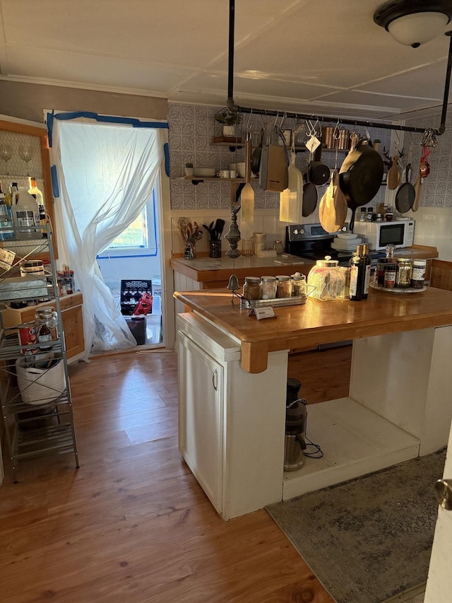 bar featuring wood finished floors and white microwave